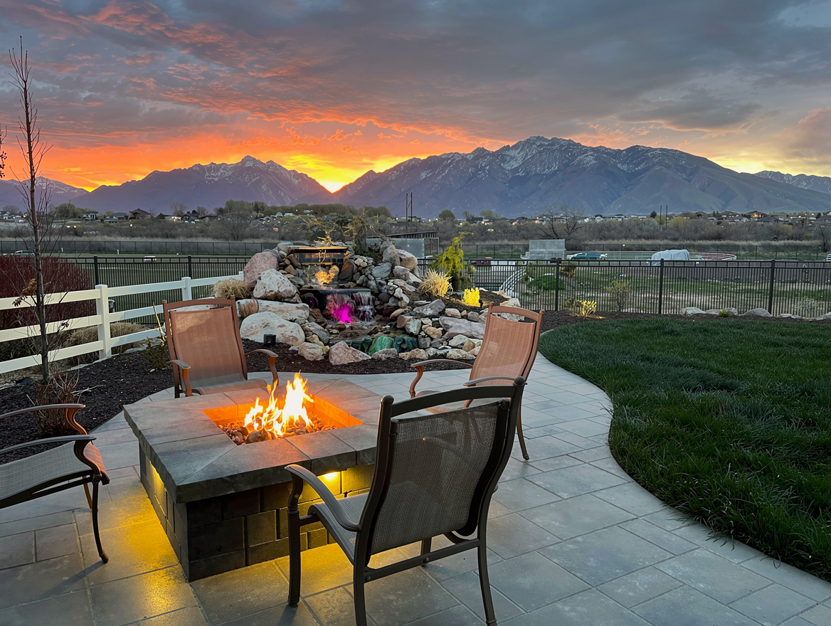 Fire pit patio with Wasatch mountain sunset backdrop and water feature — Salt Lake City, Utah