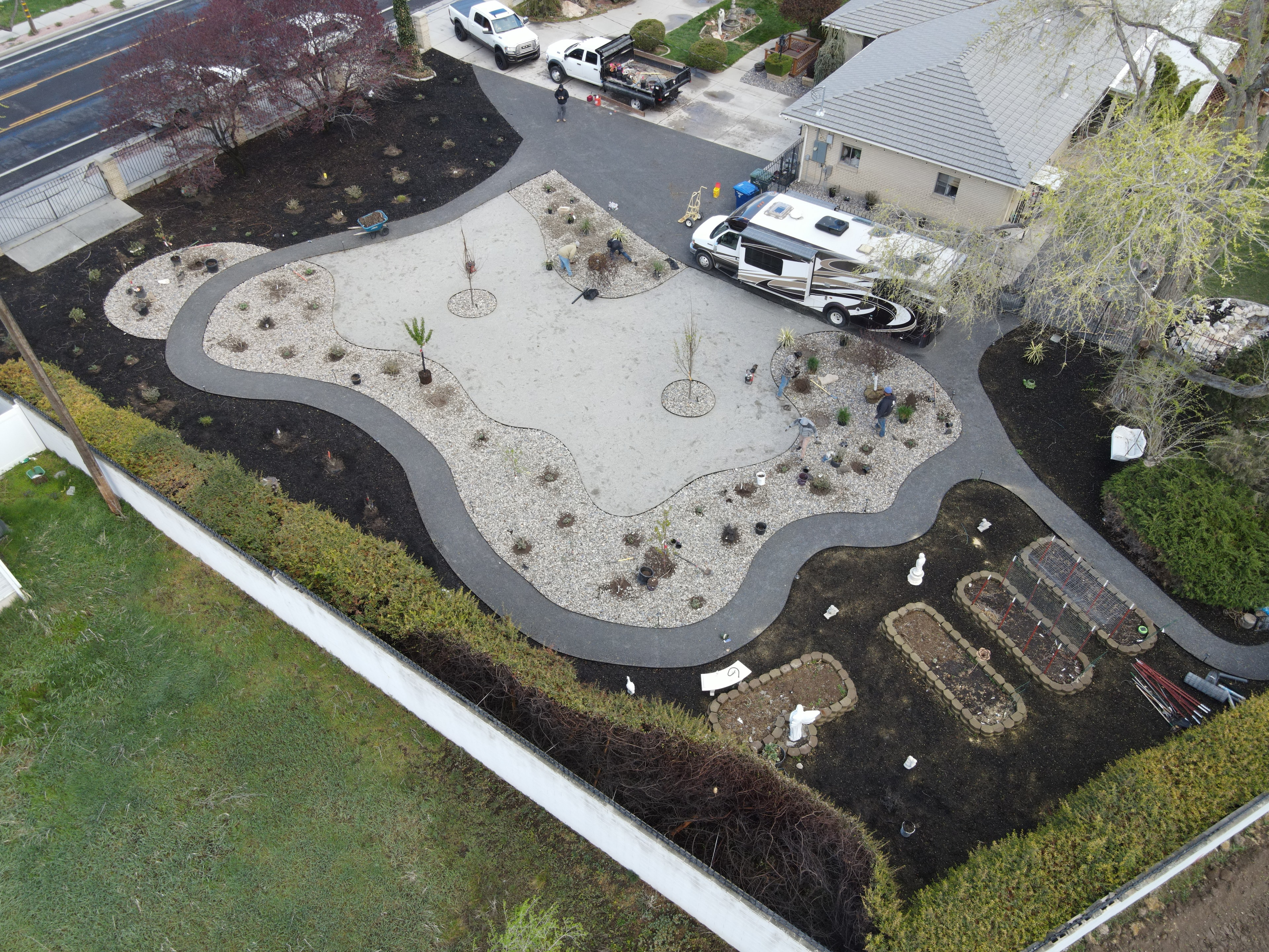 Aerial view of a xeriscape and planting installation in progress at a Utah residence