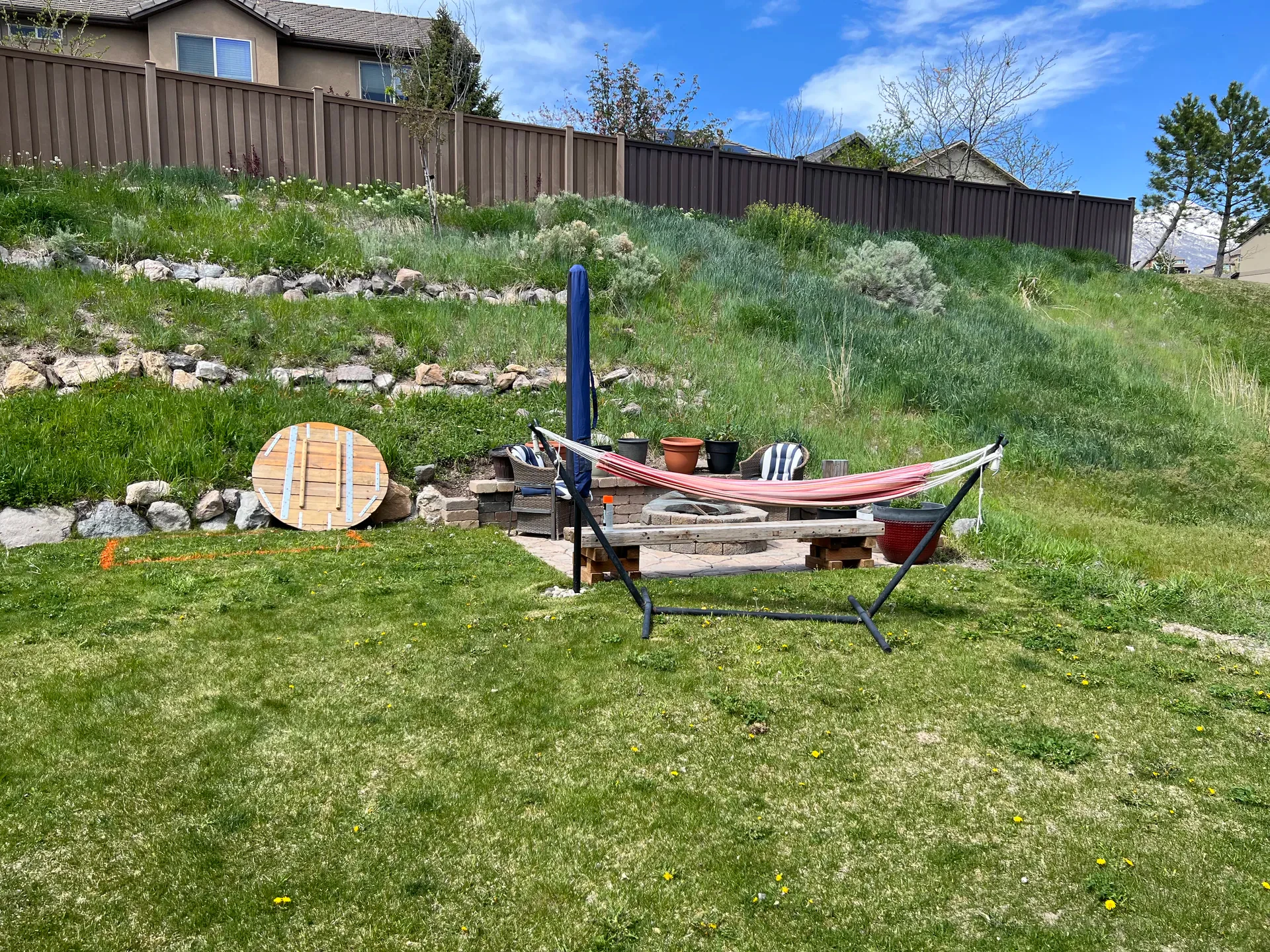 Draper backyard before renovation — hammock and unimproved slope