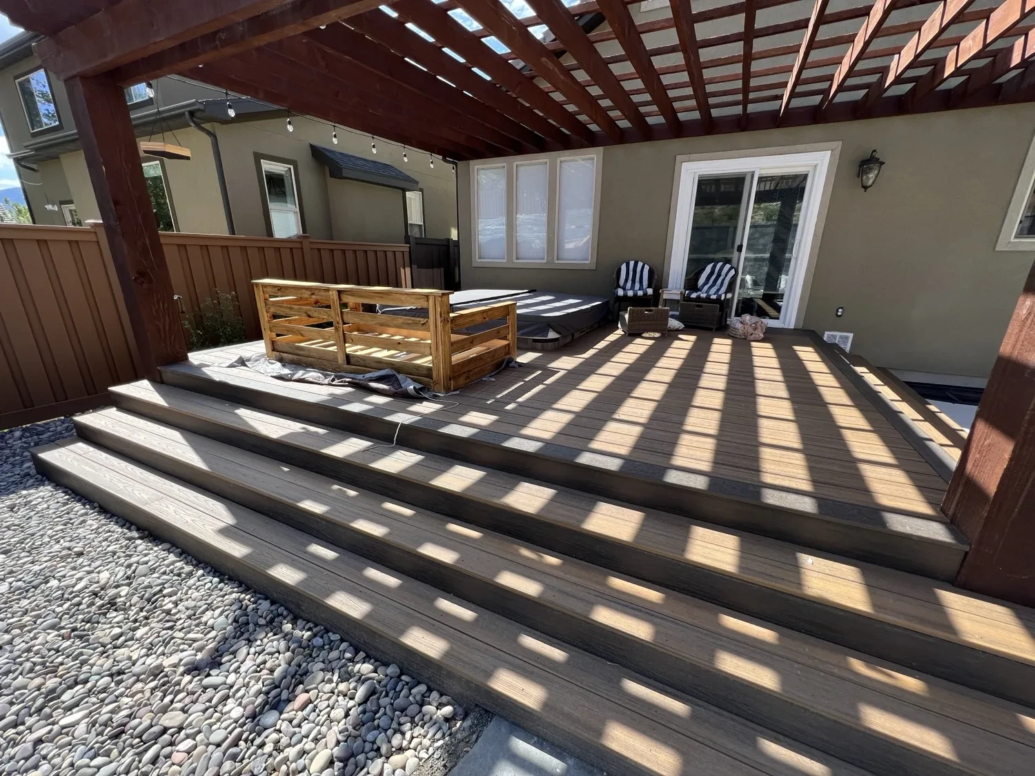 Trex Transcend Spiced Rum stair and picture-frame border with Havana Gold field decking at the Suncrest Draper outdoor-living renovation.