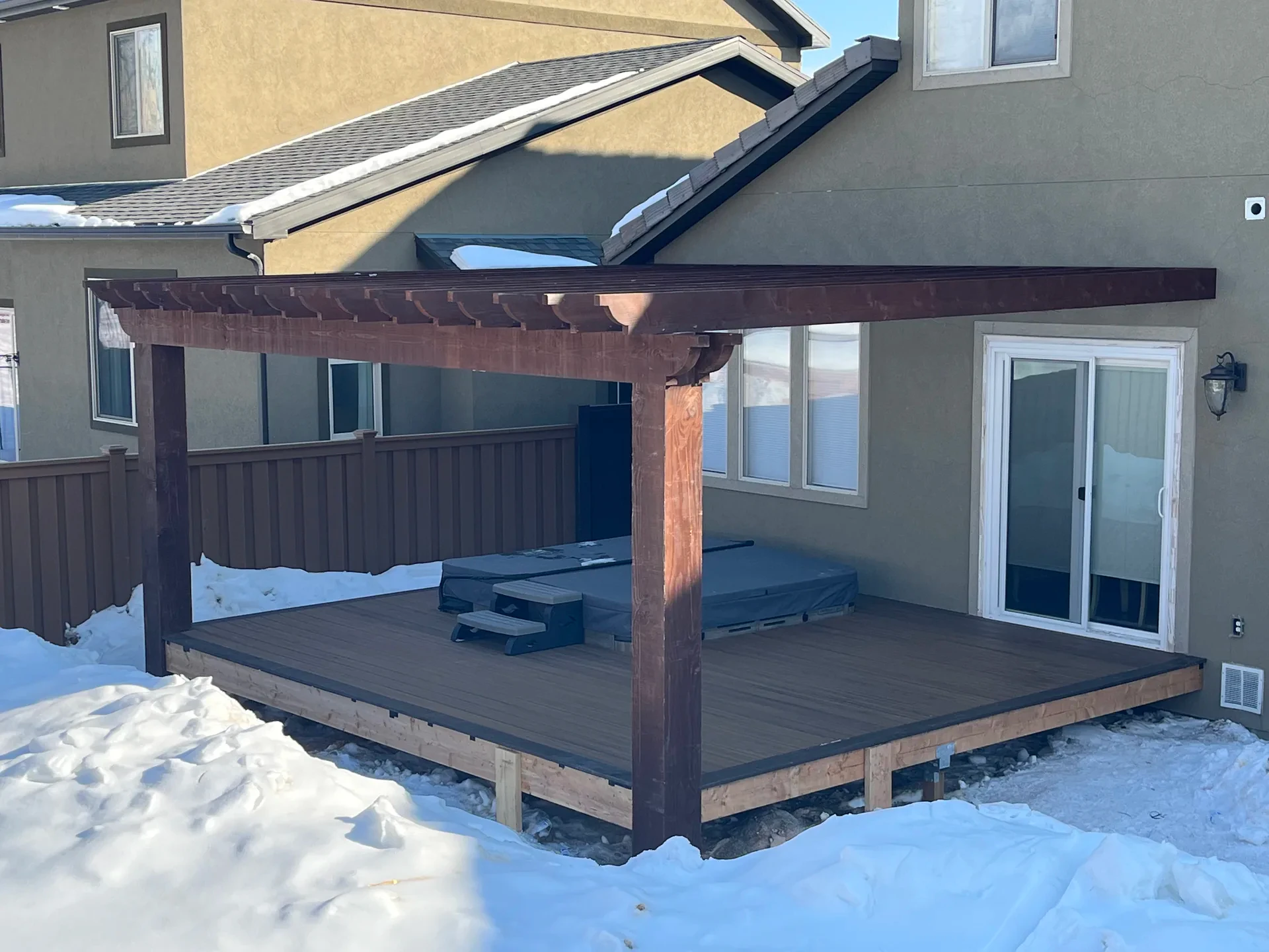 Trex deck, rough-sawn cedar pergola, and hot tub in a Draper, Utah backyard