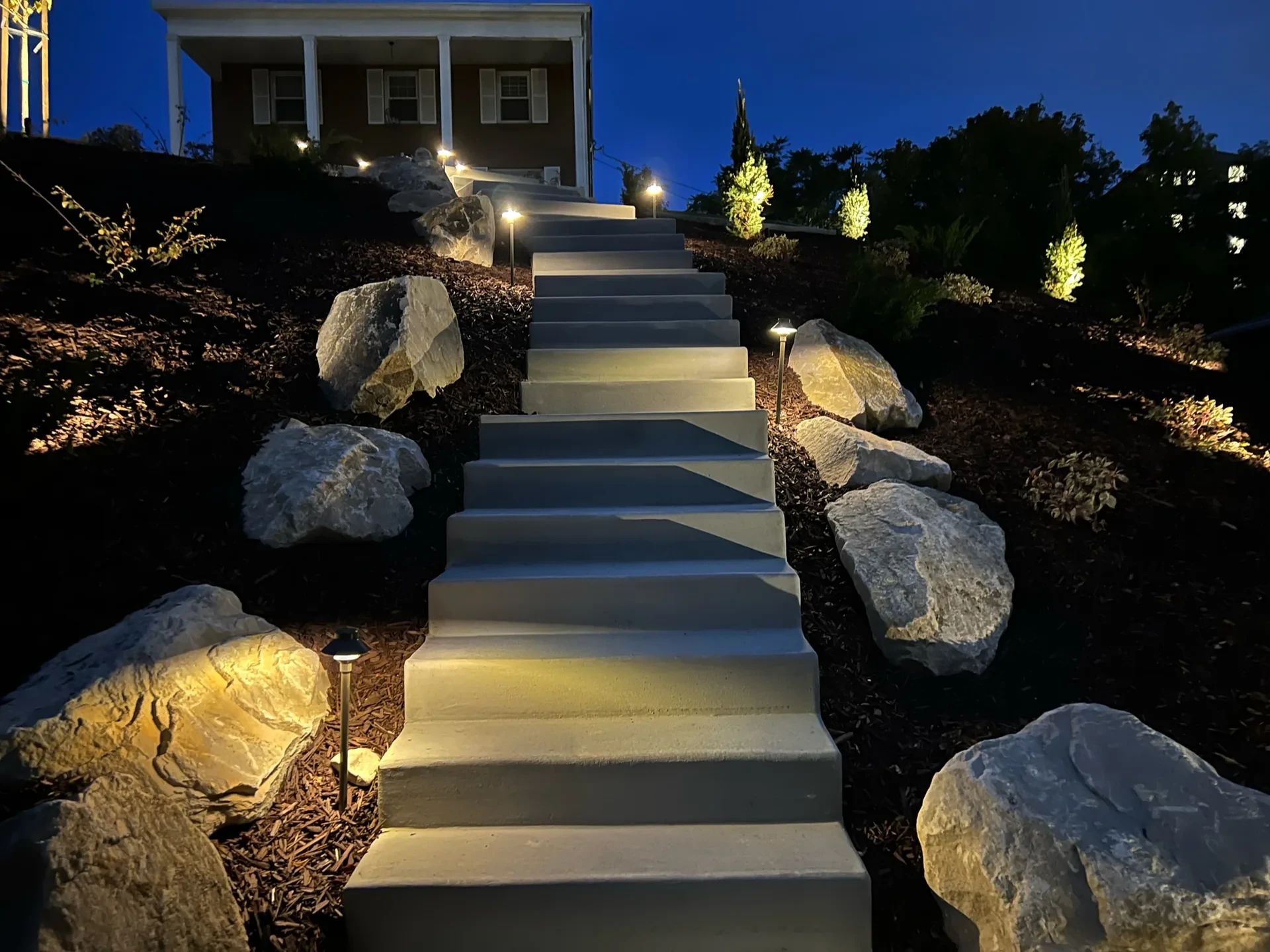 Custom concrete stairs with natural boulders and FX Luminaire landscape lighting — Federal Heights, Salt Lake City