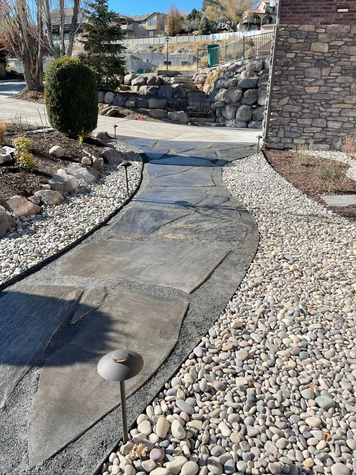 Natural flagstone pathway connecting patio to water feature