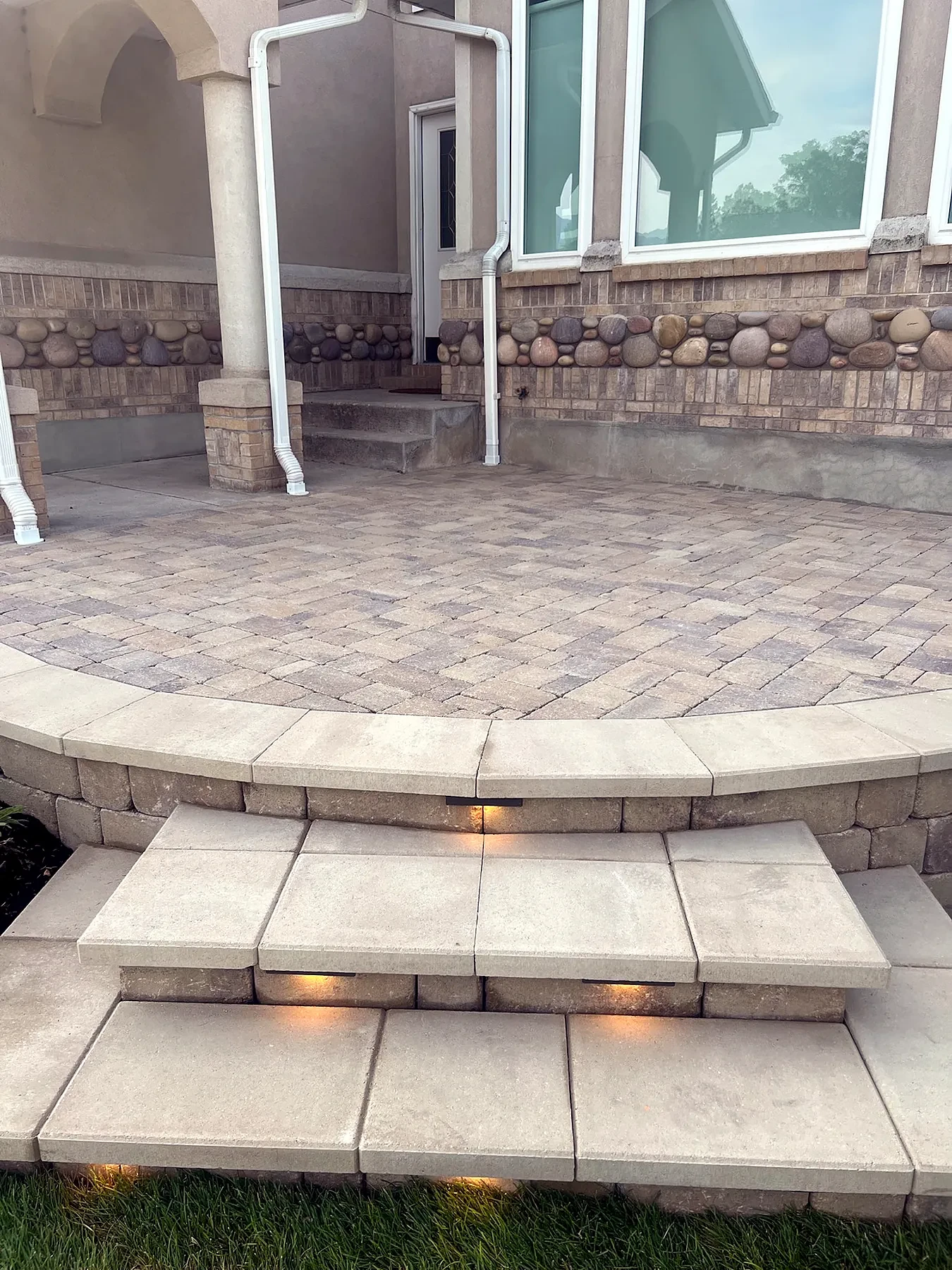 Close view of Belgard paver field and soldier-course edge on a Sandy terrace