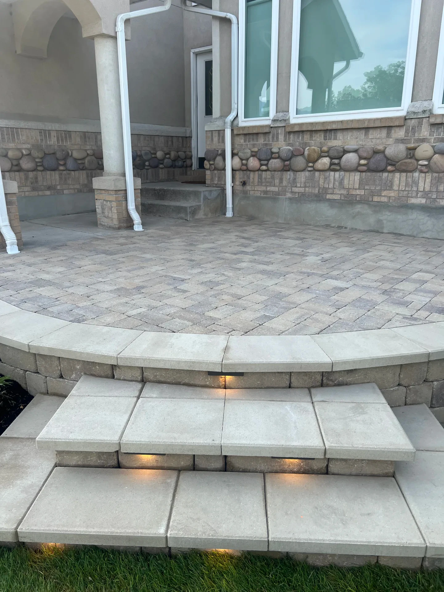Belgard paver terrace and broad entry steps with integrated FX Luminaire step lighting in Sandy, Utah