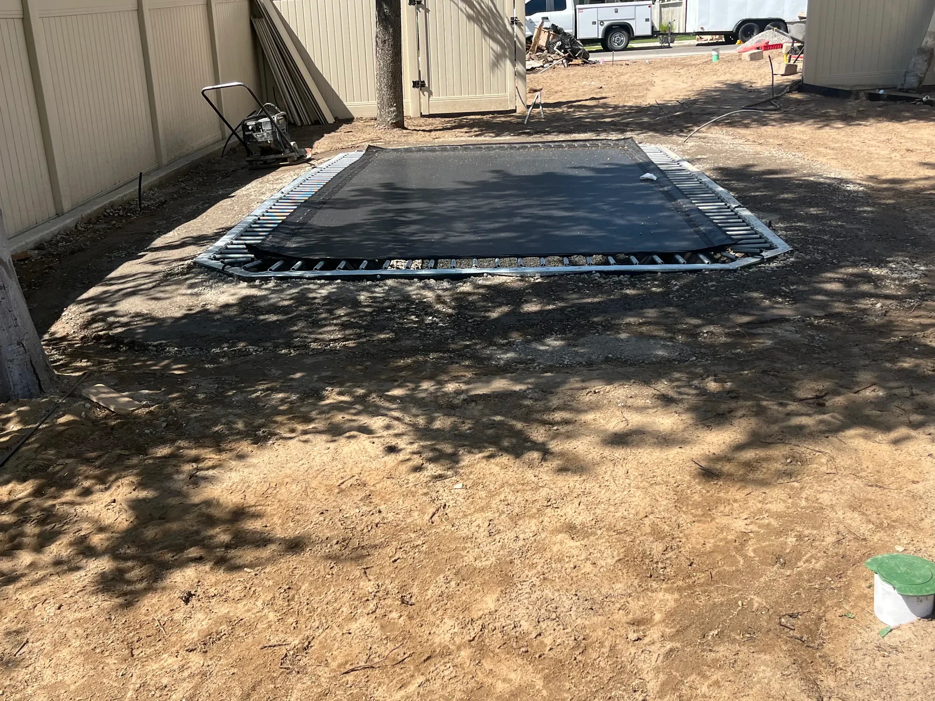 In-ground trampoline set into the Sandy backyard recreation area