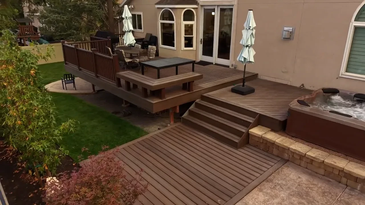 Aerial view of composite deck, hot tub, and completed backyard landscaping in Sandy, Utah, by Black Diamond Landscape & Outdoor Living.