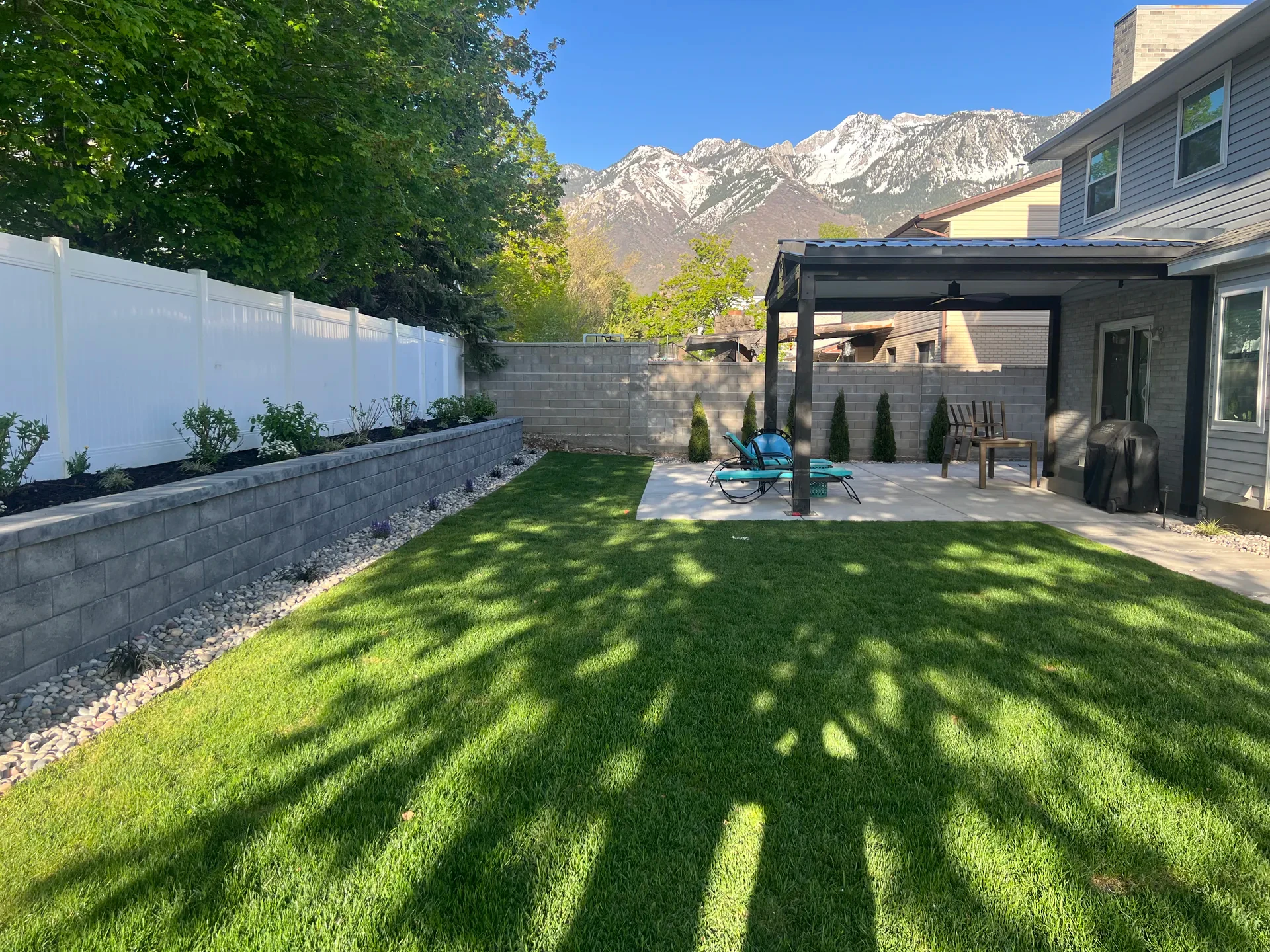Backyard with custom pavilion, Belgard retaining wall and BioGrass sod, Sandy Utah