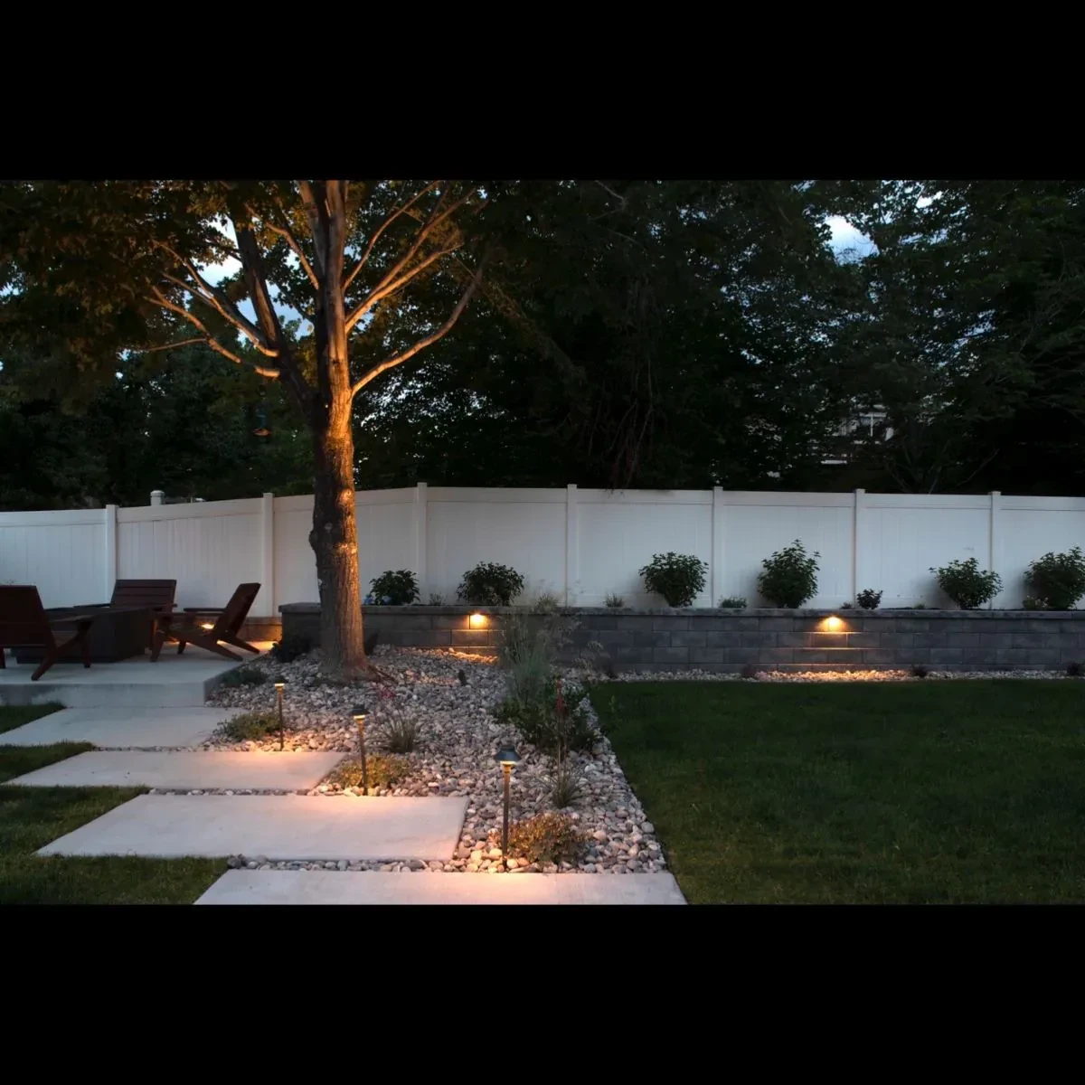 Belgard retaining wall with landscape lighting at dusk, Sandy Utah