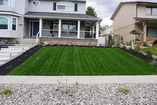 Before: Sandy Utah home front yard prior to landscape renovation — existing concrete entry and basic landscaping