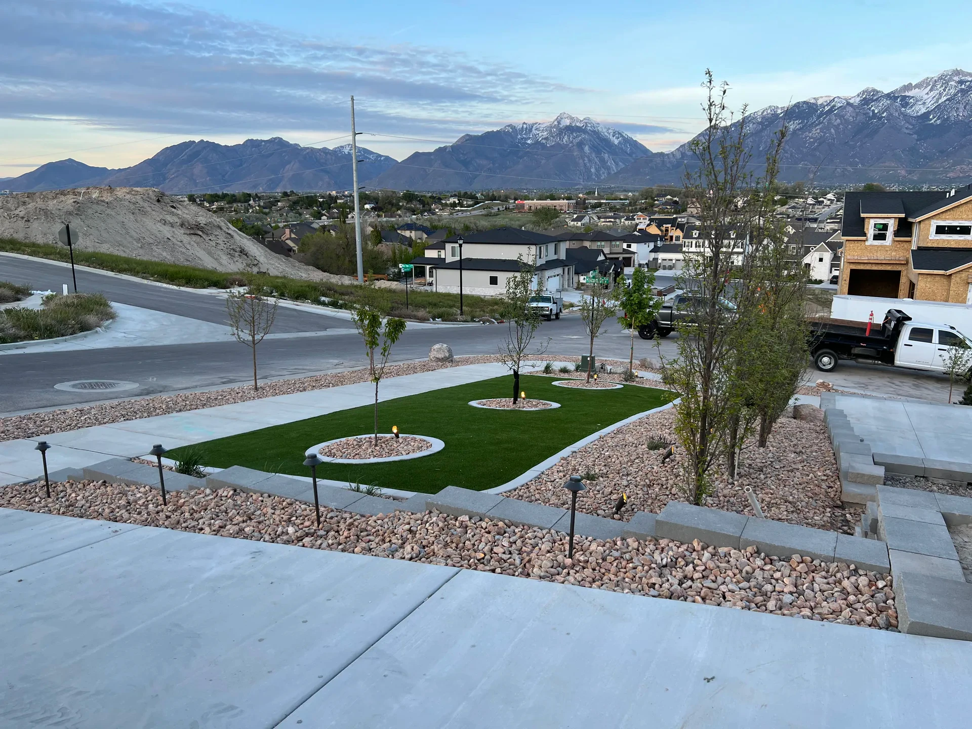 Biograss drought-tolerant sod, concrete curbing, decorative stone and mountain views in a South Jordan landscape renovation.