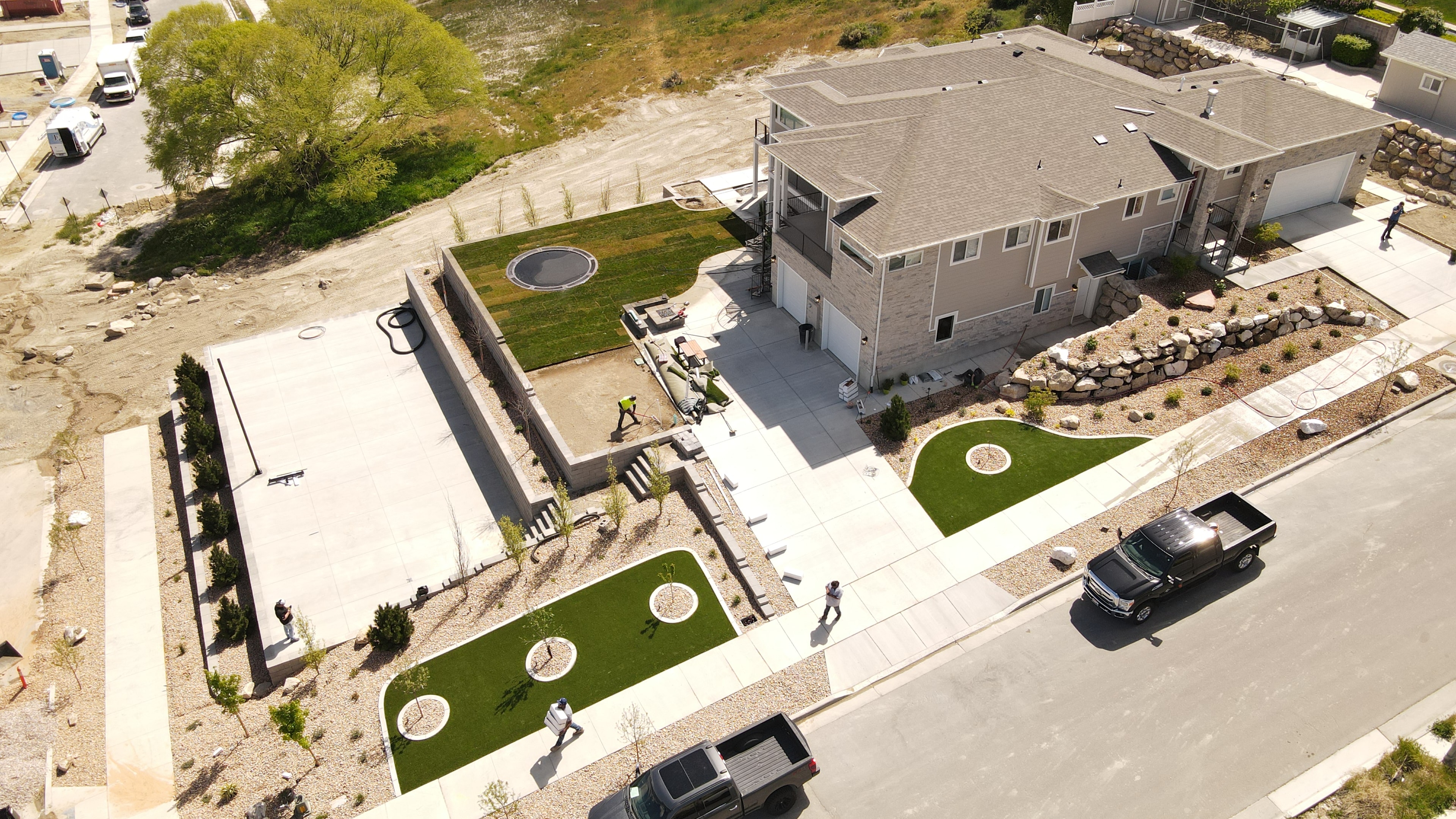 Completed South Jordan front yard — artificial turf, rock borders, and low-water planting