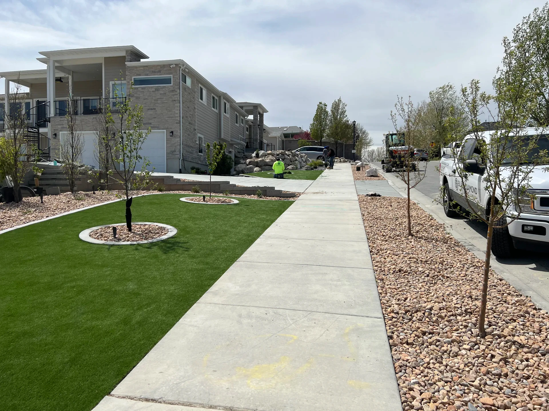 Concrete walkway and custom garden planters in a South Jordan landscape renovation.