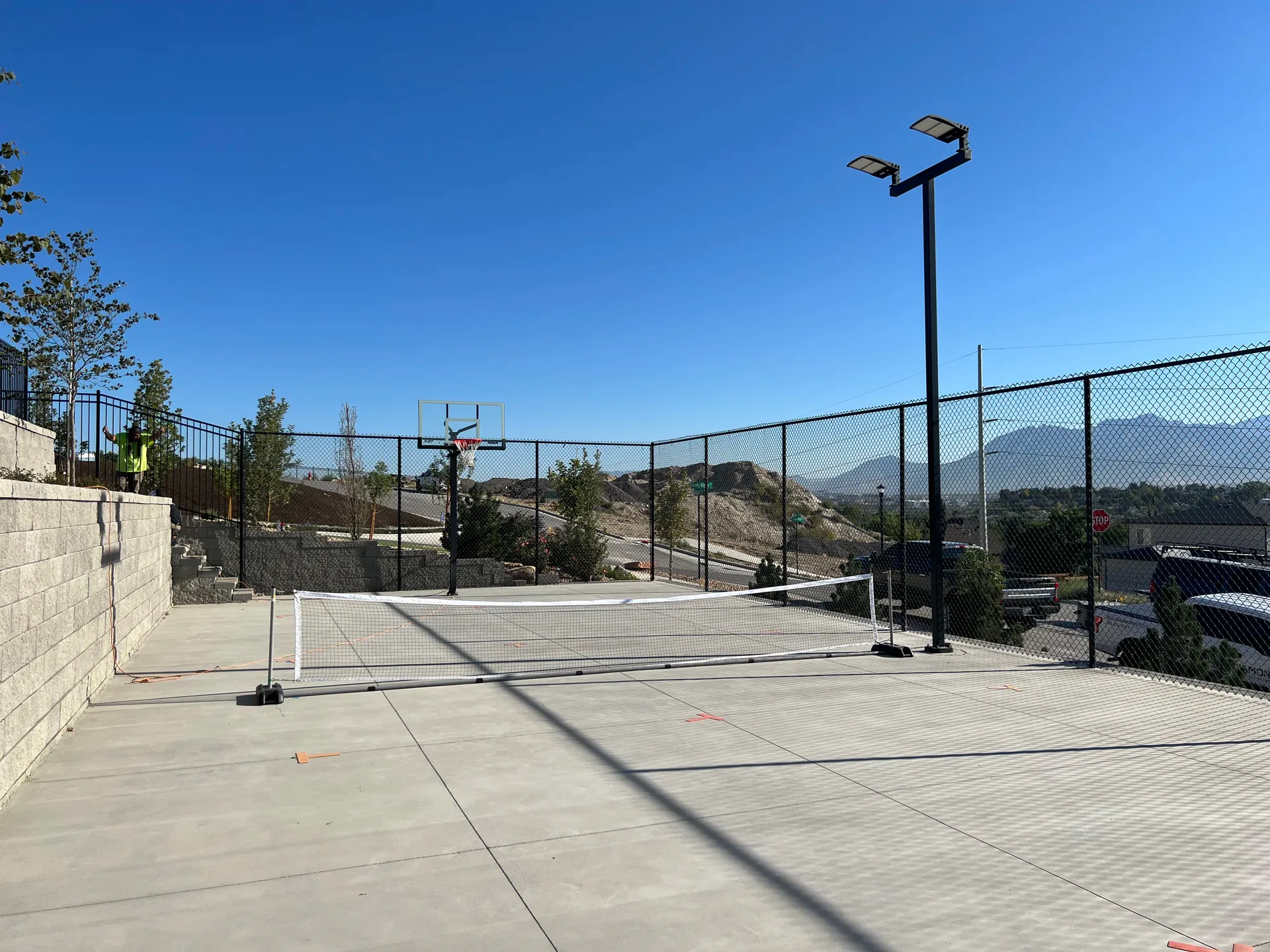 Sport-court lighting, basketball hoops and mountain views in South Jordan, Utah.