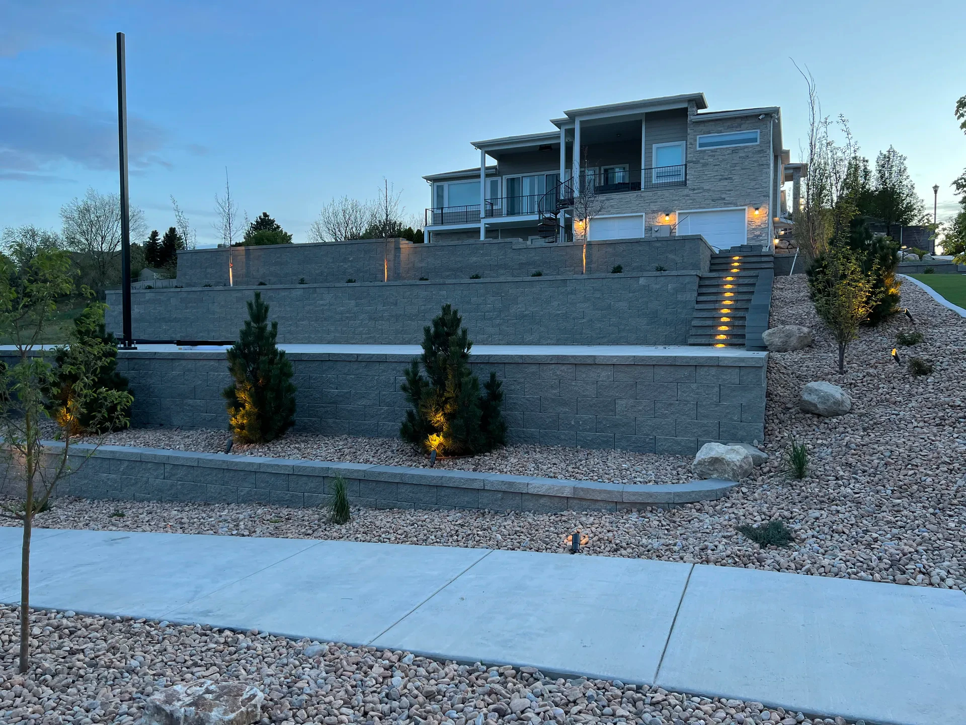 Illuminated landscape steps between engineered Belgard retaining walls in South Jordan, Utah.