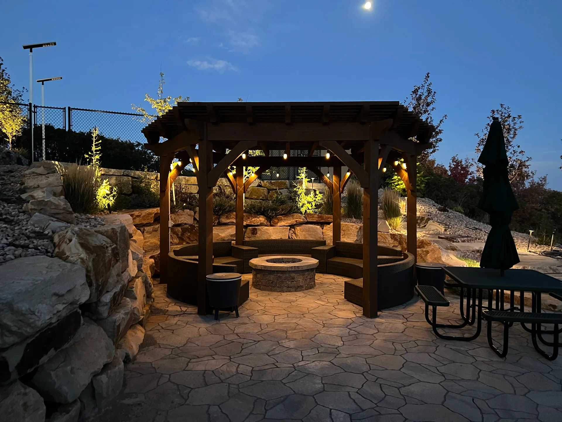 Pergola and fire pit patio illuminated at evening in Suncrest, Draper Utah