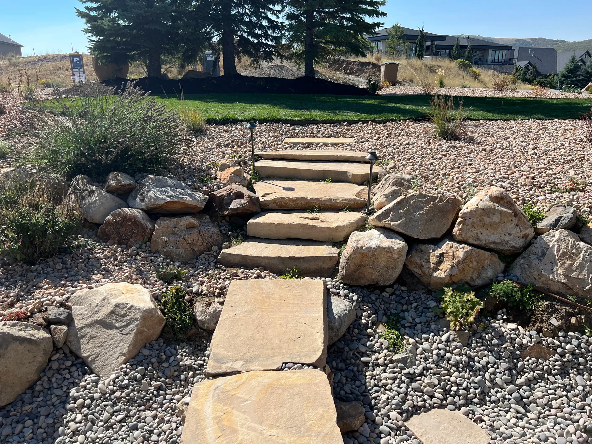 Natural slab-cut stone steps through a water-wise garden in Draper, Utah