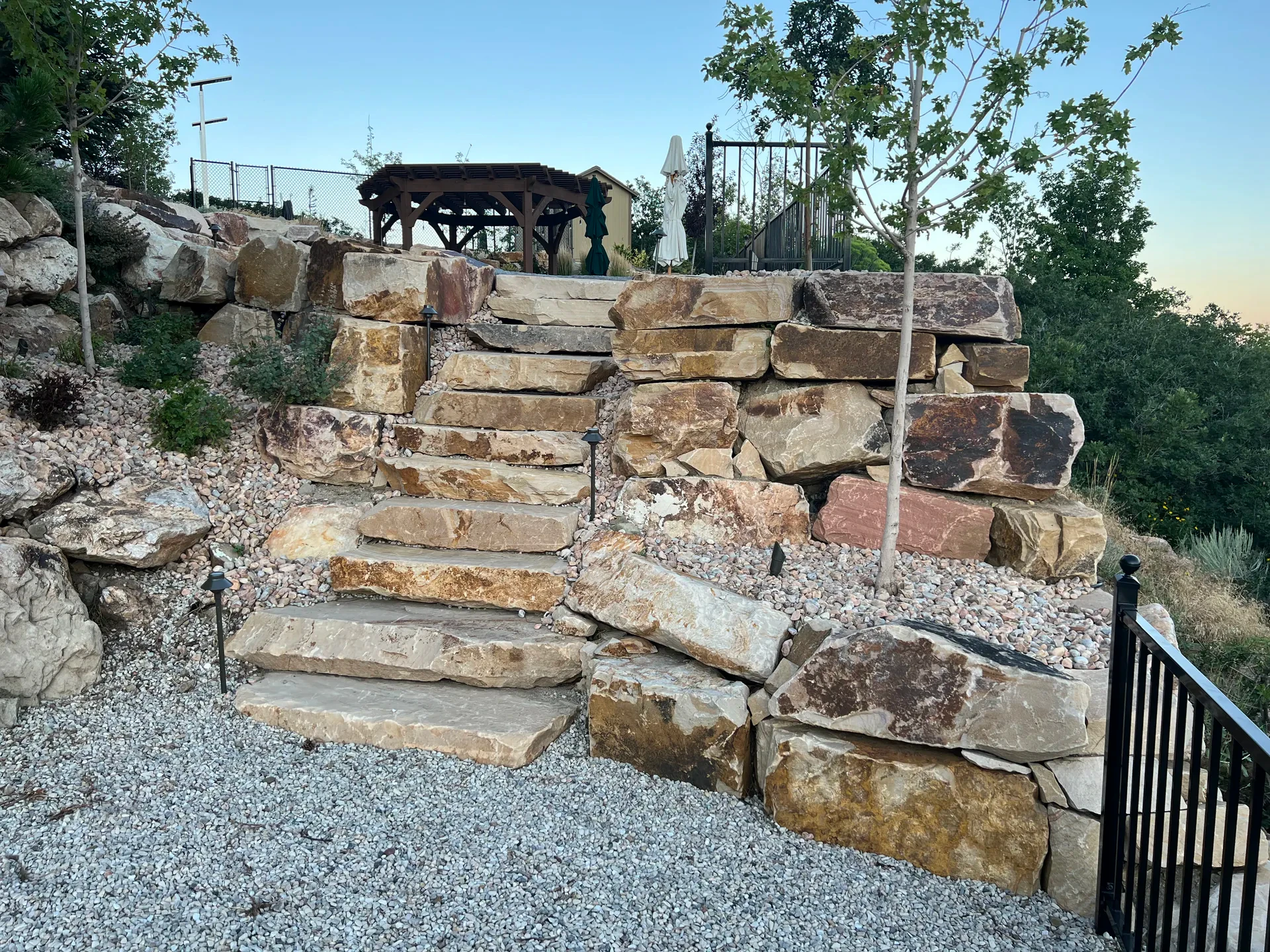 Natural slab-cut stone stairs alongside retaining walls in Suncrest, Draper Utah