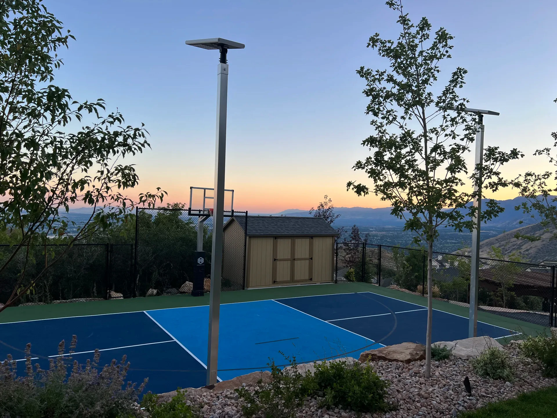 Sport court with landscape lighting and valley view at dusk in Suncrest, Draper Utah