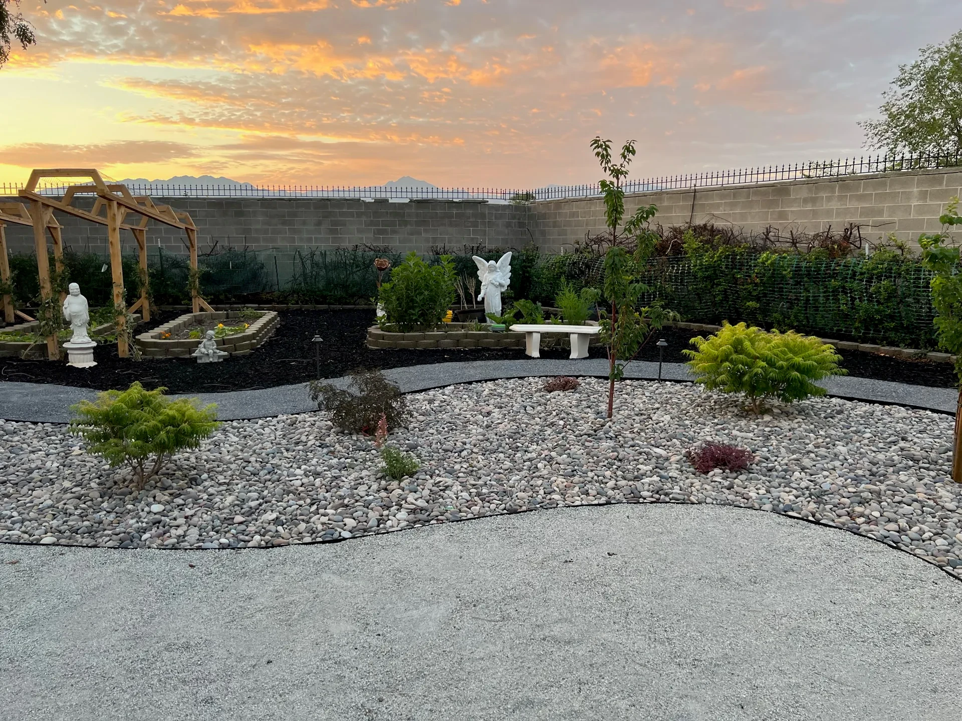 West Valley City landscape detail with decorative stone, drought-tolerant shrubs, ornamental planting and curving path