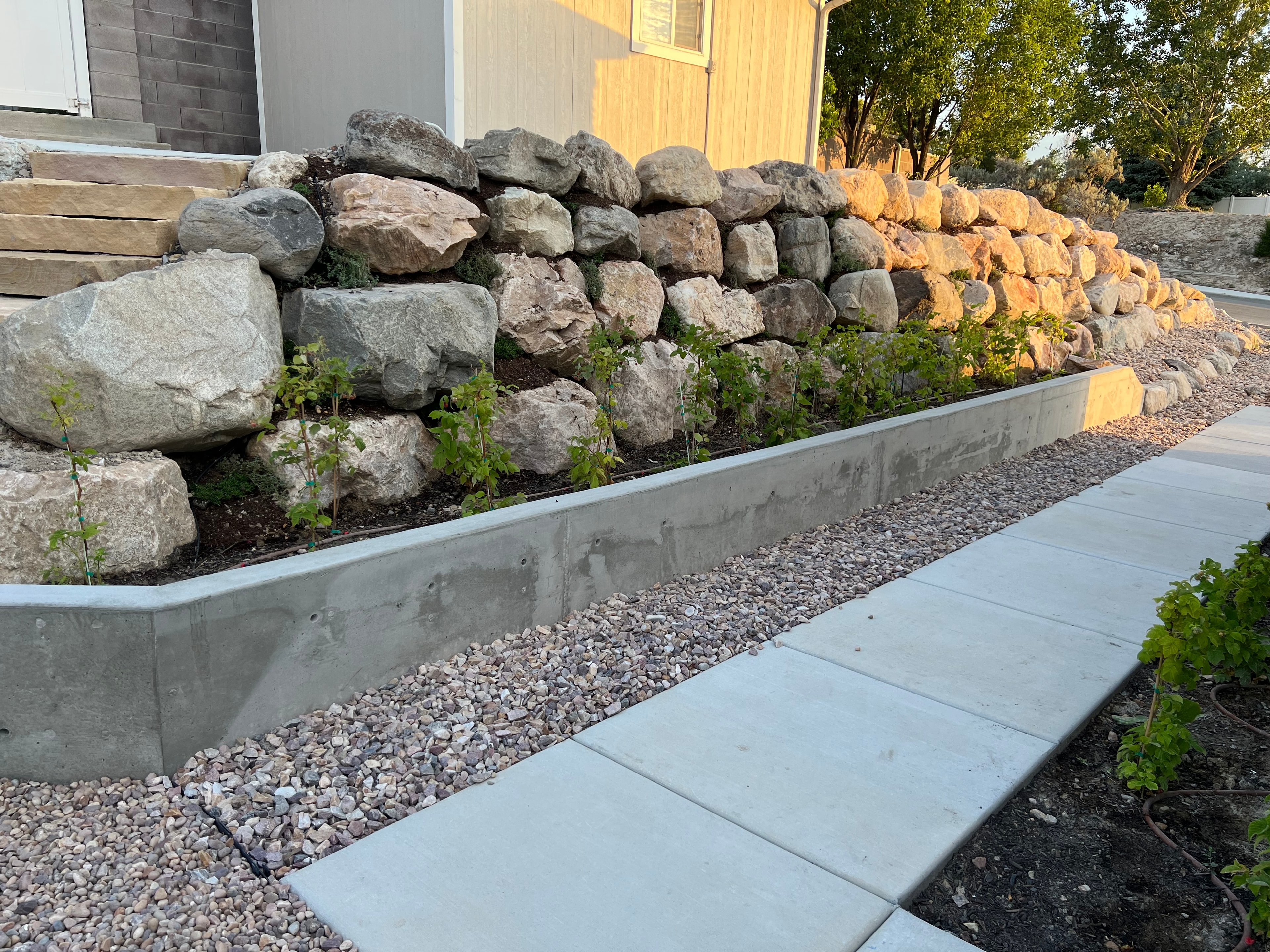 Stacked boulder retaining wall — Black Diamond Landscape project