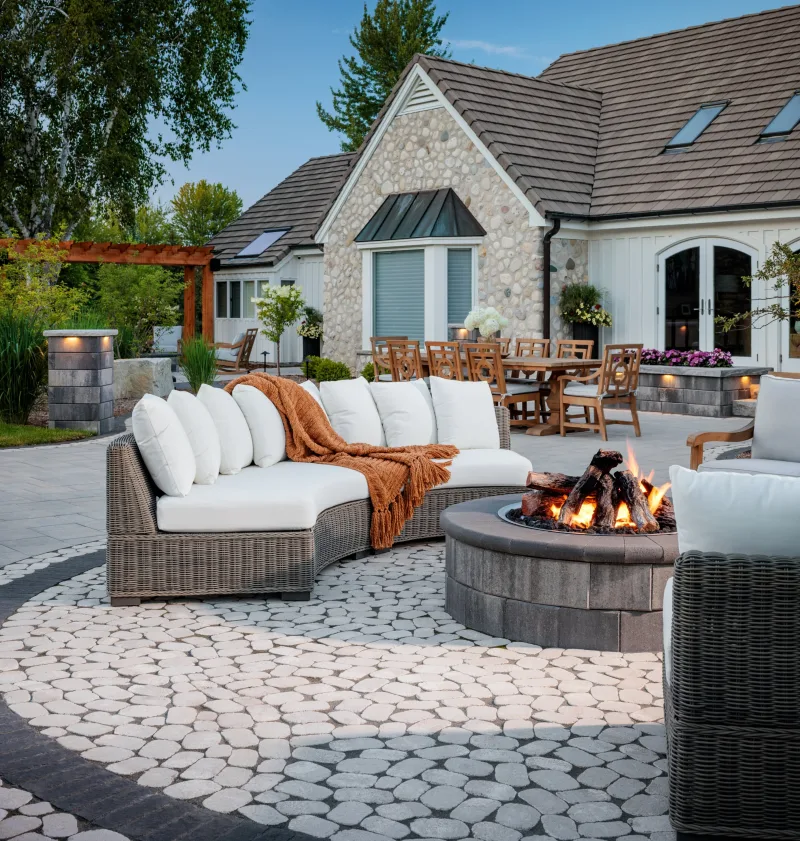Belgard Dimensions 18 patio with Melville Tandem Wall columns, Marina Coping caps, and outdoor kitchen — manufacturer inspiration.