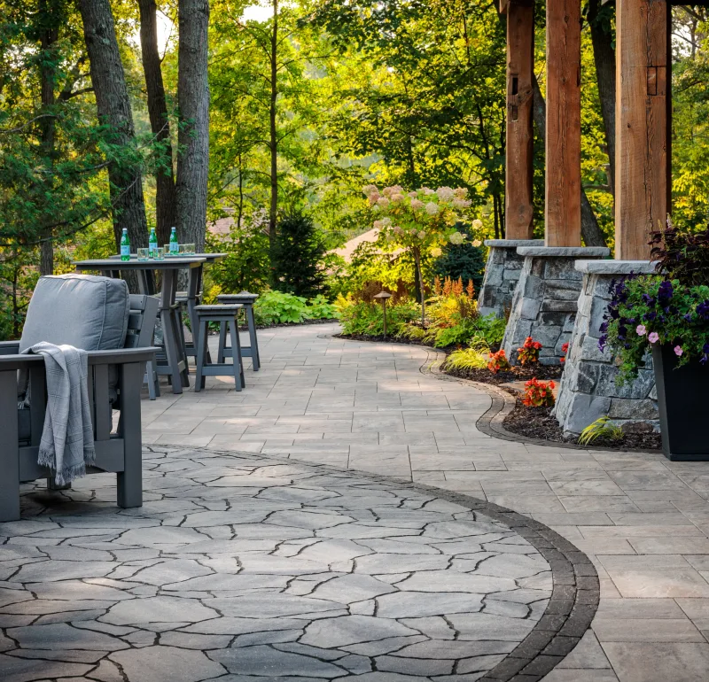 Belgard MegaArbel irregular flagstone patio with Origins 12 field and Brooklyn Paver border — manufacturer inspiration.
