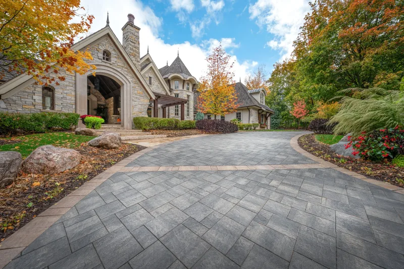 Belgard Origins 12 driveway apron in Newport Grey and Aspen colourways with Brooklyn Paver border — manufacturer inspiration.