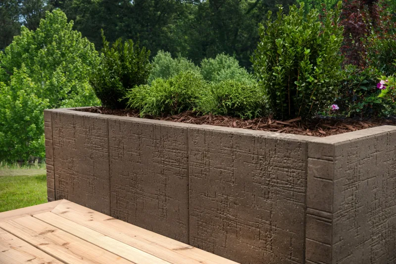 Belgard Artforms Papyrus raised planter box with cedar seat bench and Empire Paver field — manufacturer inspiration.