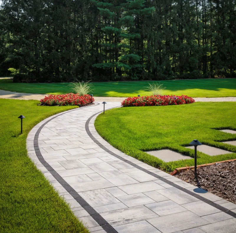 Belgard Dimensions 12 curved pathway with Brooklyn Paver border edging — manufacturer inspiration.