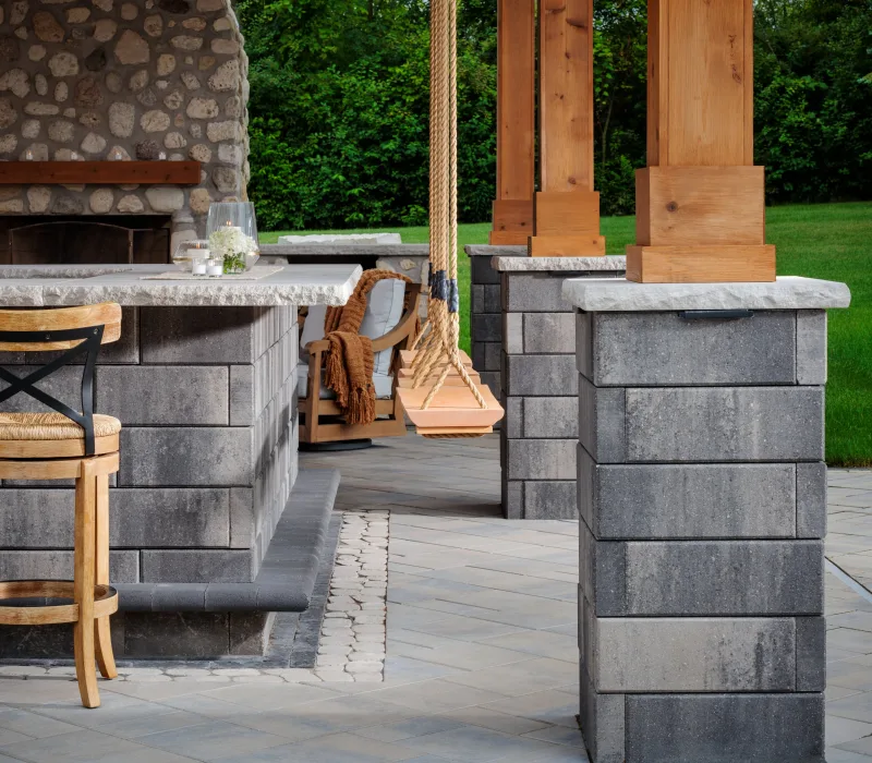 Belgard Melville Tandem Wall columns with Marina Coping, outdoor kitchen bar, and Dimensions 18 patio floor — manufacturer inspiration.