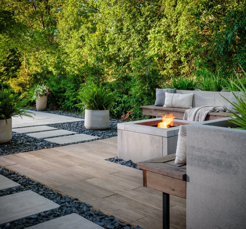 Belgard DimensionsSlab 24x36 Mirage contemporary patio with Artforms seat wall, gas fire feature, and slate gravel infill — manufacturer inspiration.