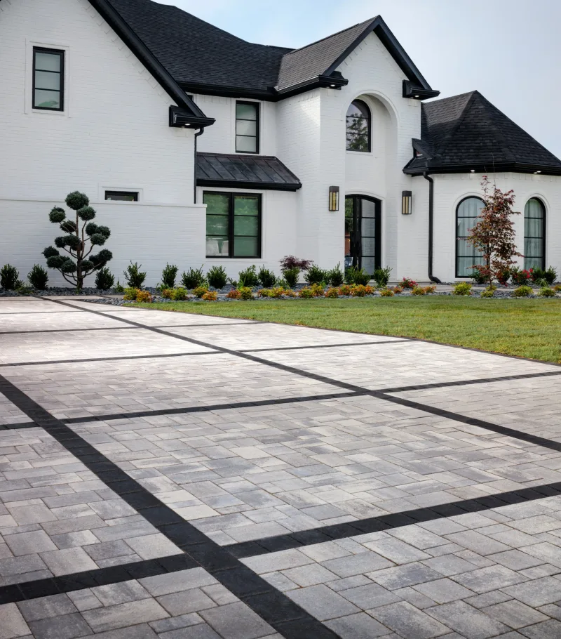 Belgard Dimensions 6 driveway with bold Dimensions 6x9 Accent geometric grid overlay at luxury home — manufacturer inspiration.