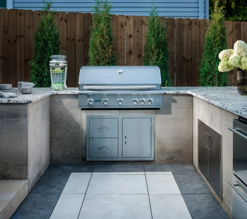 Belgard Artforms U-shaped outdoor kitchen with Elements grill close-up and Quarziti 2.0 floor — manufacturer inspiration.